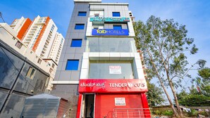 A multi-story building with a sign for 'Whitefield Suites' and 'Fab Hotels'. - Fabhotel Whitefield Suites (Bengaluru)