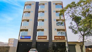 A multi-story building with signs for 'Tab Hotels', 'Restaurant', and 'Hotel GK'. - Fabhotel The Nation (Mohali)