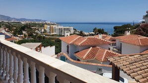 A coastal view with terracotta-roofed buildings, a clear blue sky, and a distant sea. - Villa - Casa del Sol! Detached villa with pool, outdoor terraces near the beach! (Nerja)