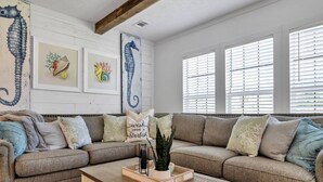 A living room with a beige sofa, a wooden coffee table, and a patterned rug. - 30A Santa Rosa Beach 3mi to Private Beach and Mall (Santa Rosa Beach)