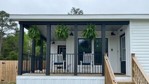 A covered porch with a wooden staircase, a white railing, and hanging plants. - 30A Santa Rosa Beach 3mi to Private Beach and Mall (Santa Rosa Beach)