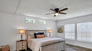 A bedroom with a wooden bed, two bedside tables with lamps, a ceiling fan, and a window with blinds. - 30A Santa Rosa Beach 3mi to Private Beach and Mall (Santa Rosa Beach)