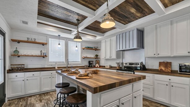 A modern kitchen with a large island, white cabinetry, and a rustic ceiling. - 30A Santa Rosa Beach 3mi to Private Beach and Mall (Santa Rosa Beach)