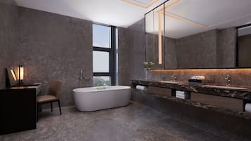 Un baño moderno con una bañera grande, un tocador con dos lavamanos y un espejo amplio.