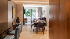 A modern dining area with a wooden table, chairs, and a sofa. - Embrace the Now: 203 Industrial's Sunlit Serenity Awaits (Mexico City)
