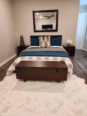 Restful retreat with a large bed, nightstand, and plush rug.