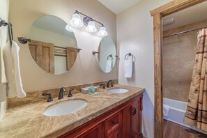 A bathroom with two sinks, a large mirror, and a shower curtain. - Large and Comfortable Condo w/ Loft (Mammoth Lakes)