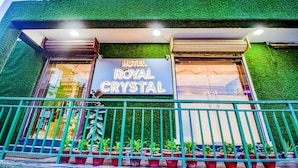 A hotel named "Royal Crystal" with a green facade and a signboard. - Fabhotel Royal Crystal (Bhubaneshwar)