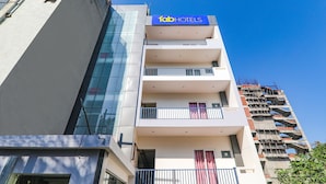 A modern hotel with a glass facade, multiple balconies, and a prominent 'Tab Hotels' sign. - Fabhotel The Comfort (Prayagraj)