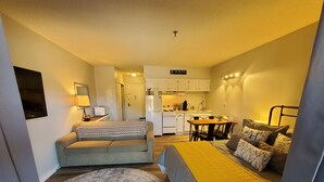 A compact studio apartment with a kitchenette, a sofa, a bed, and a dining area. - ESCAPE TO THE PERFECT WHITE MOUNTAIN LOCATION - Cozy Condo @ Lincoln Station (Lincoln)