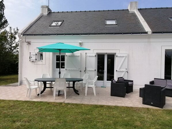 Enjoy al fresco dining on the covered patio with a dining table and comfortable seating.
