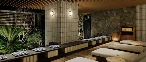 A spa area with wooden benches, a stone wall, and a ceiling with wooden slats.