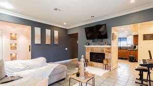 A modern living room with a sofa, a coffee table, and a fireplace. There is a kitchen area visible in the background. - Cozy 2 bedroom apartment in Las Vegas (Las Vegas)