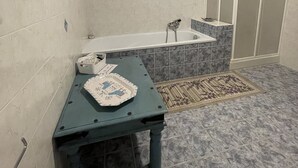 A bathroom with a bathtub, a shower, and a toilet.