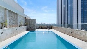 A rooftop pool with a clear view of a city skyline, surrounded by modern buildings. - Elite Signature (Nairobi)