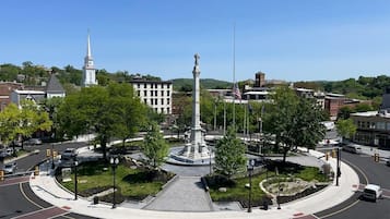 A roundabout with a central monument, surrounded by greenery and intersecting roads.