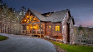 A large log cabin with a prominent front porch and multiple windows. - Whiskey Hollow Lodge - Mountain Views | Outdoor Living | Hot Tub (Morganton)