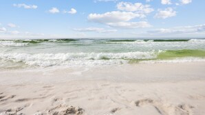 A beach with waves, clear sky, and footprints in the sand. - Oceanfront Oasis. Expansive balcony, cozy decor, stunning views over the dunes. (Fort Walton Beach)