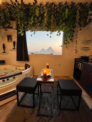Honeymoon Double Room | Living area | 60-inch LCD TV with satellite channels - Pharaoh pyramids view  (Giza)