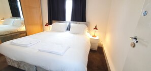 Cozy retreat with a large bed, two bedside tables, and soft lighting.