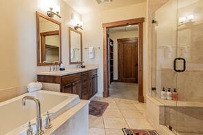 Bathtub, hair dryer, towels, shampoo