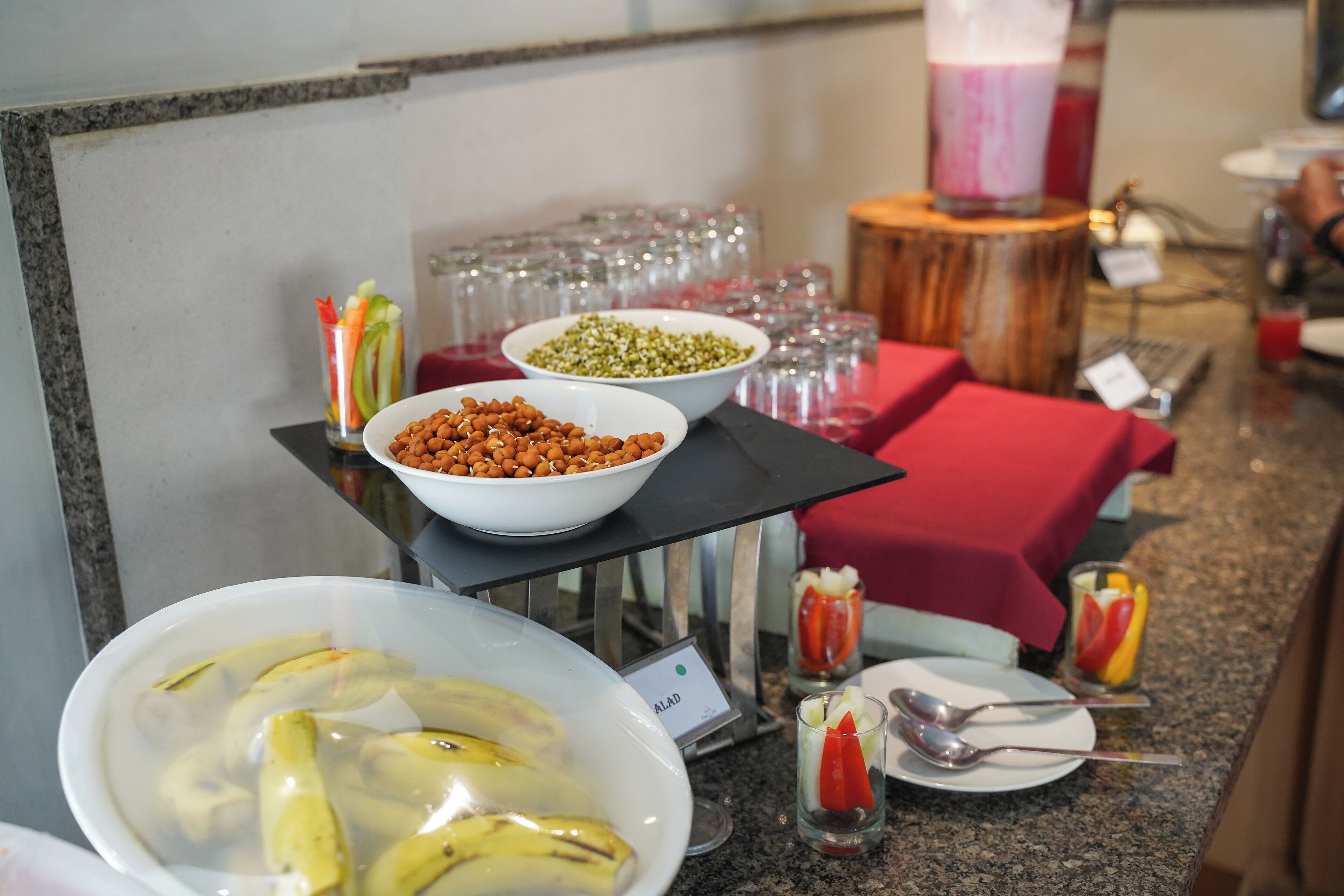 A buffet setup with various food items and beverages.