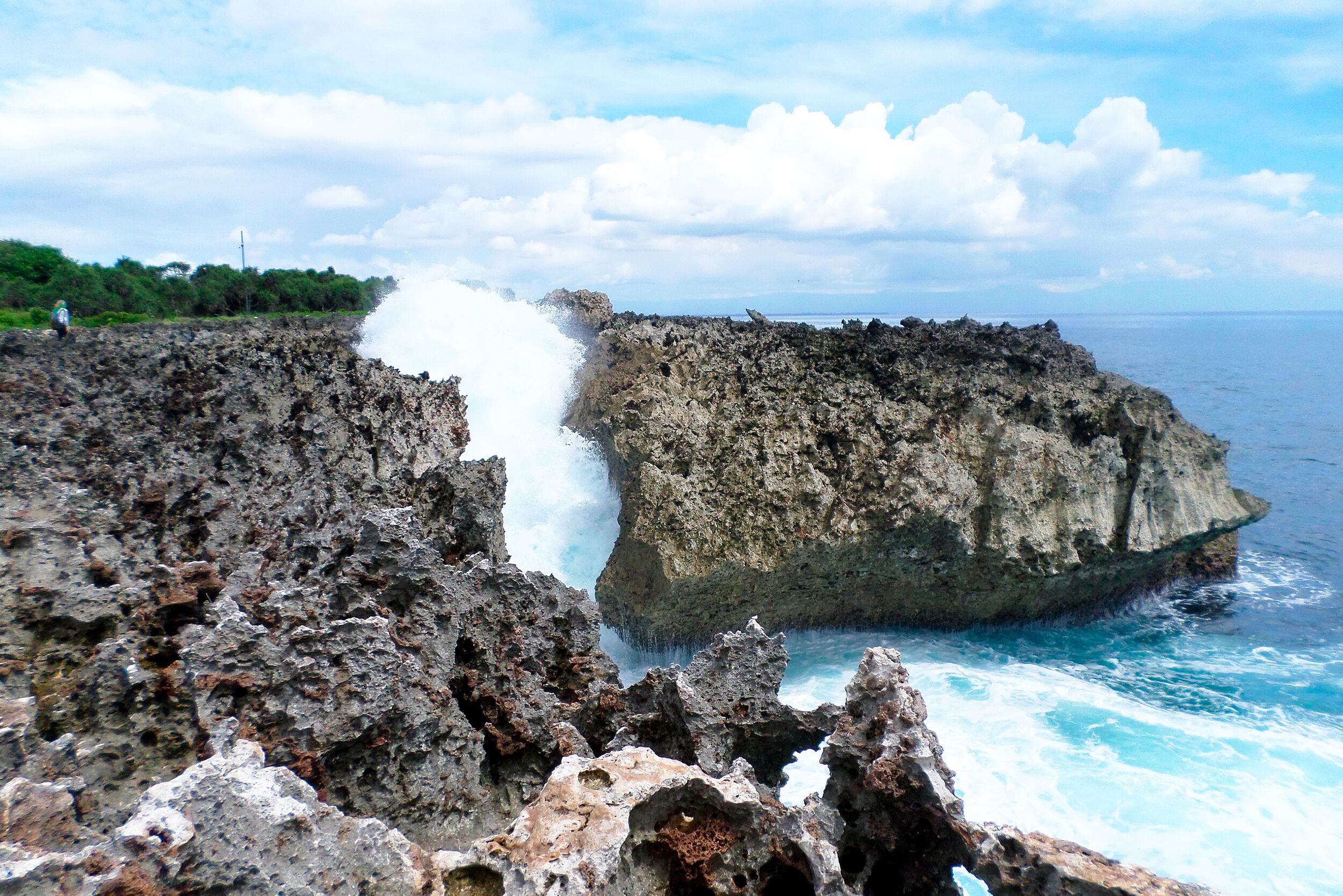 A rocky coastline with waves crashing against the rocks.