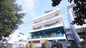 A multi-story building with a sign indicating it is a hospital. - Wedlock Hotels (Gurugram)