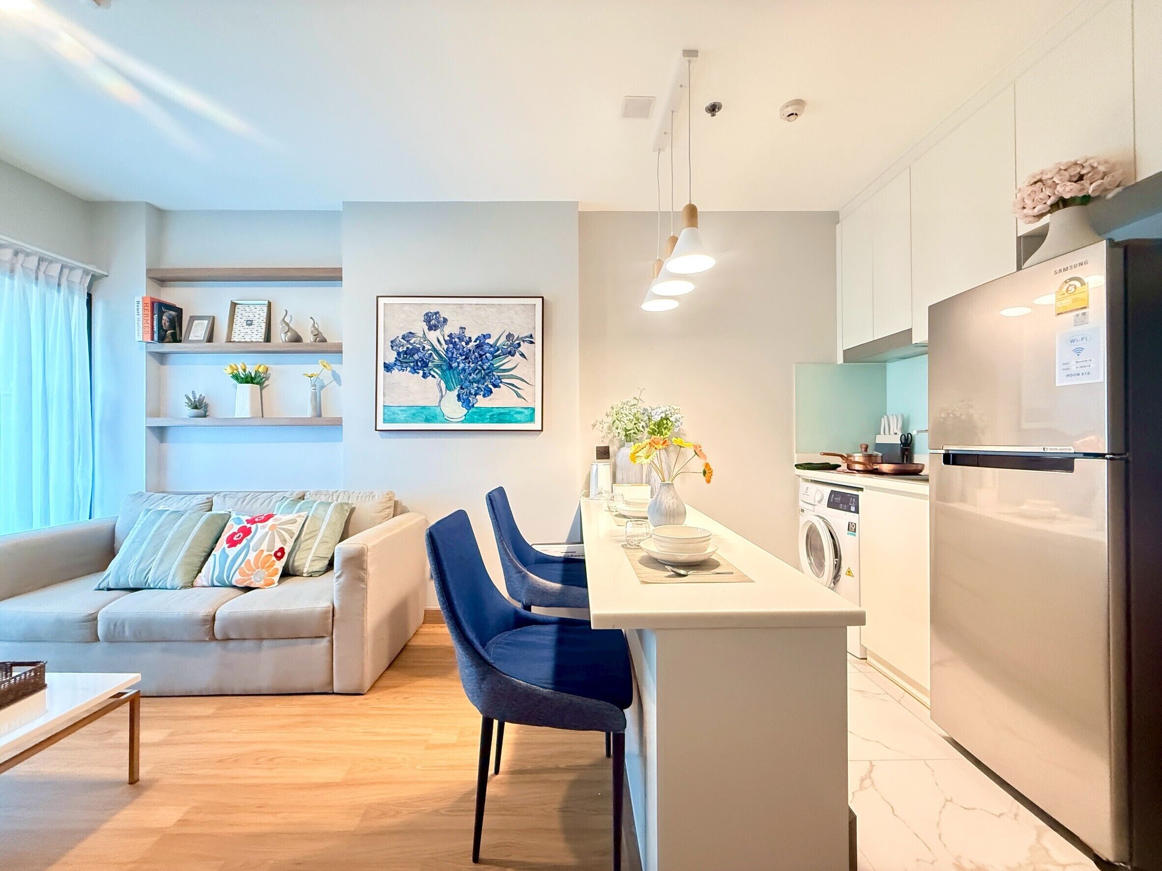 A modern apartment with a living room, a kitchen, and a dining area.