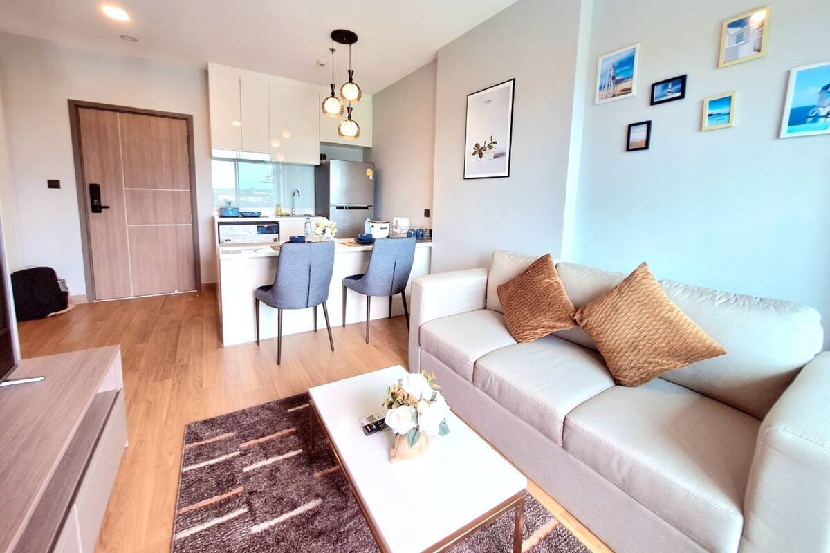 A modern apartment with a kitchen, dining area, and living room.