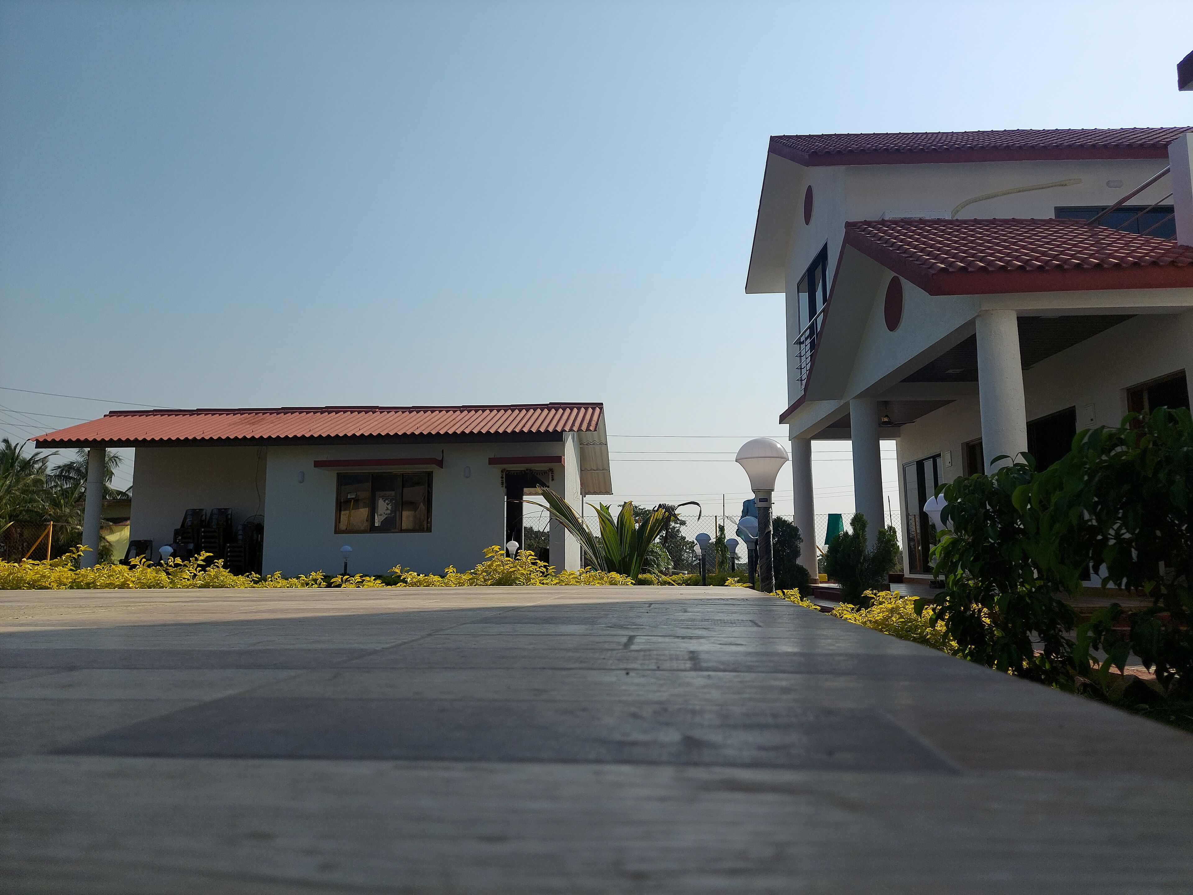 A building with a red-tiled roof and a covered walkway.