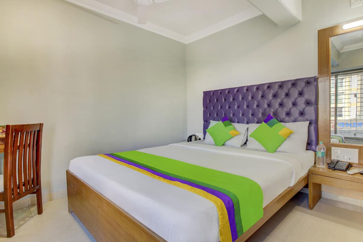 Desk, iron/ironing board, bed sheets