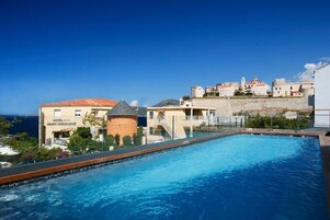 Seasonal outdoor pool, open 7:00 AM to 8:30 PM, pool umbrellas
