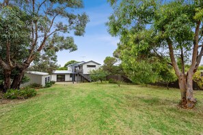 A residential property with a house, a covered outdoor area, and a lawn. - Three Beaches (Anglesea)