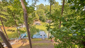 A lakeside view with a dock, a gazebo, and a small building. - Treetop & Waterfront! Quiet Cove, Hot Tub, Kayaks, Game Room and more (Moneta)