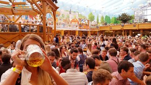 A crowded indoor event with wooden structures and a festive atmosphere. - Munich Central Camping (Munich)