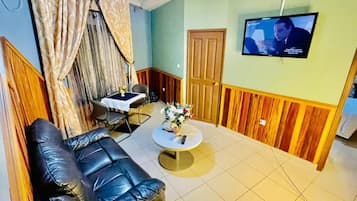 Luxury Studio Suite | Living area | 32-inch LED TV with cable channels, TV, printers
