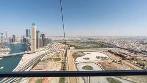 A cityscape with high-rise buildings, a river, and a bridge. - Lux BnB I Amna Tower I Panaromic Views (Dubai)