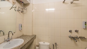 A bathroom with a sink, toilet, and shower. - Madpackers Rishikesh (Yamkeshwar)