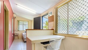 A bedroom with a bed, a desk, and a chair. - The Normanby - For the traveller on a budget (Yeppoon)