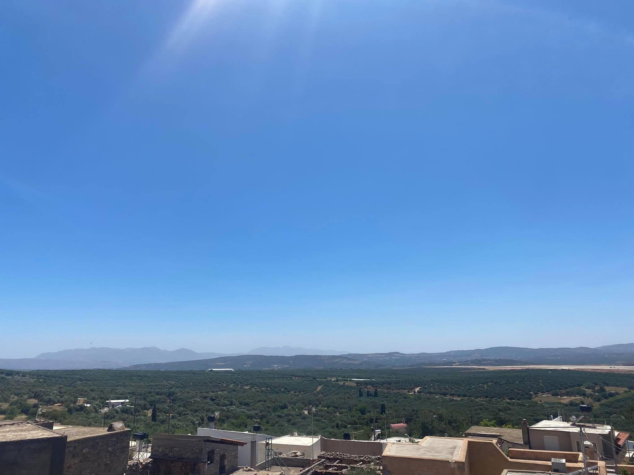 A high vantage point overlooking a cityscape with a clear sky.