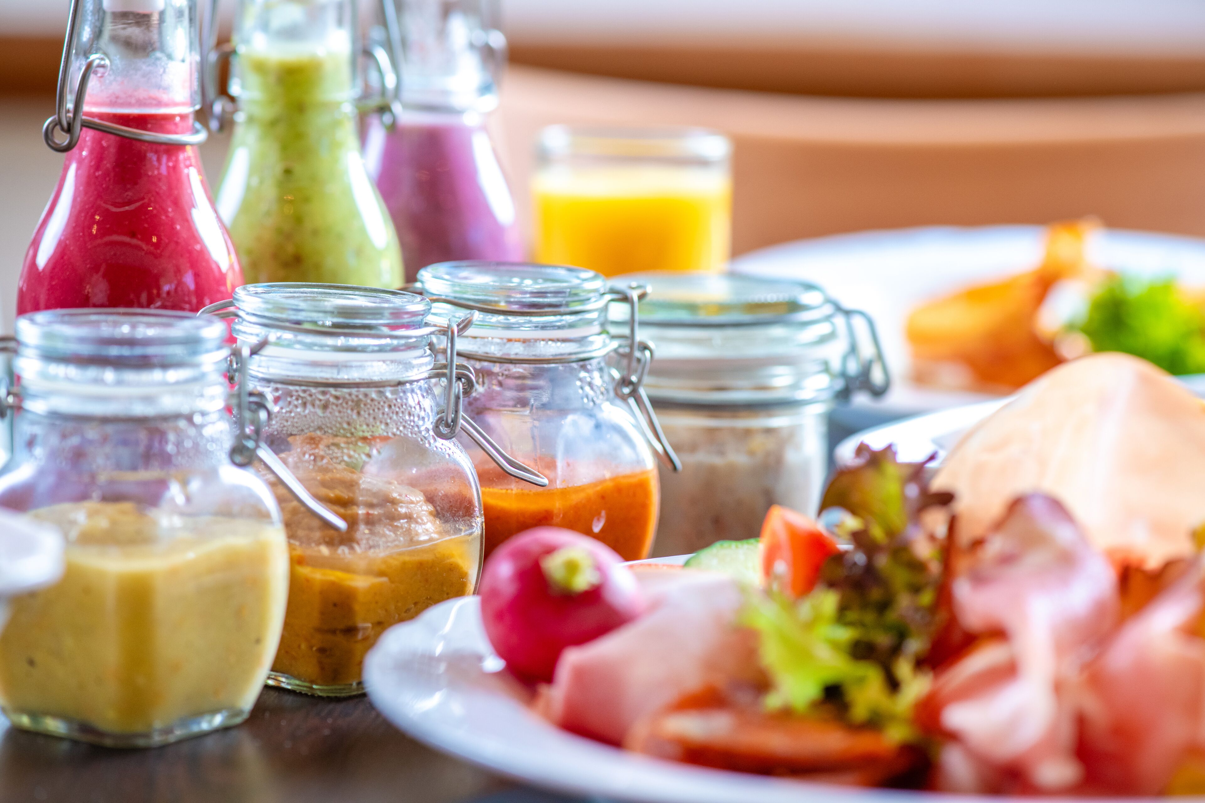 A meal with various condiments and a salad on a plate.