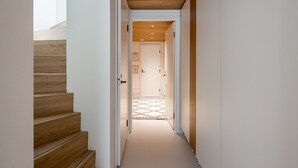 A narrow hallway with wooden stairs on the left and a wooden ceiling. - Nordic townhouse with own sauna at the city center of Helsinki (Helsinki)