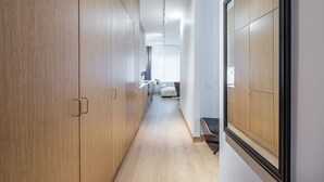 A hallway with wooden cabinets and a modern interior design. - Nordic townhouse with own sauna at the city center of Helsinki (Helsinki)