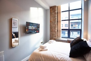 Relax in a stylish room with a large bed, flat-screen TV, and city views.