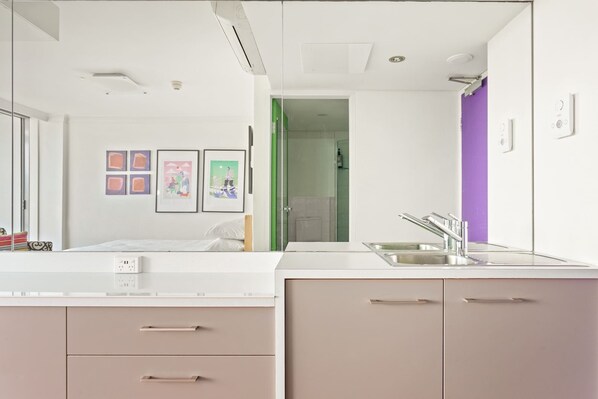 A modern bathroom with a sink, mirror, and cabinets.