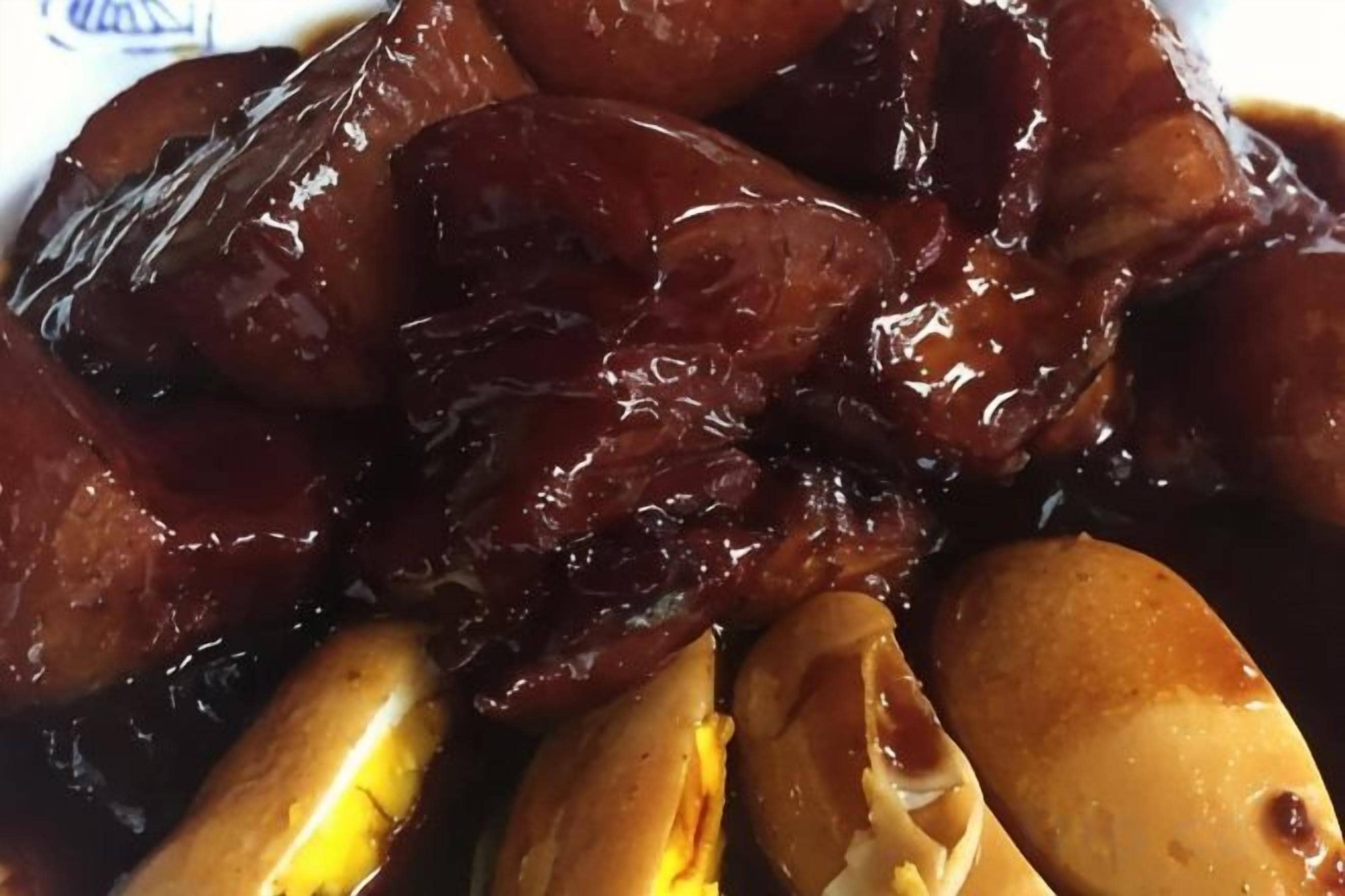 A close-up of a dish with glazed meat and vegetables.