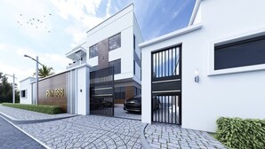 A modern two-story house with a garage, a paved driveway, and a well-maintained lawn. - Tokyo Apartments  (Abuja)