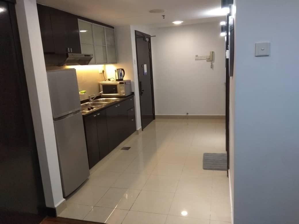 A modern kitchen with stainless steel appliances, a microwave, and a coffee maker.