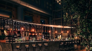 An outdoor bar area with a long counter, multiple stools, and a canopy. - Van der Valk Hotel Paris CDG Airport (Roissy-en-France)